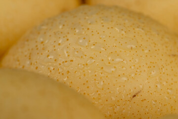 ripe white pear with a yellow colour on the table
