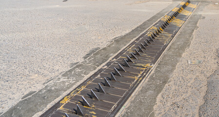 metal spikes in the asphalt, tire spike strip, spike barrier, one-way traffic spike, tire killer