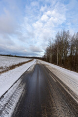 a dirty slippery road in winter after a snowfall