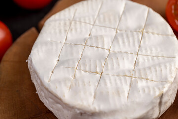 soft cheese with mold and ripe small red tomatoes