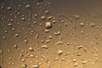 wet glass in cloudy weather, part of the glass from the window in water droplets during a light rain