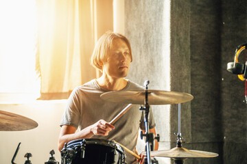 Drummer sitting at drum kit in recording studio, artistic portrait, creative inspiration, musician...