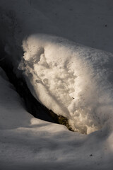 Light shining on a batch of snow left over from the winter in Finnish nature in early spring