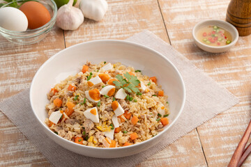 Salted eggs fried rice,stir fry egg with cooked rice minced pork and salted egg in white plate.