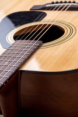 Fototapeta premium Classical guitar close up. Acoustic guitar on wood background.Music instrument concept