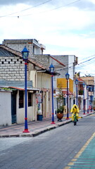 Man in a protective suit riding a bicycle during COVID-19 in Cotacachi, Ecuador