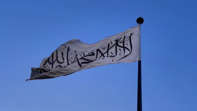 national modern flag of Afghanistan on a blue-sky background