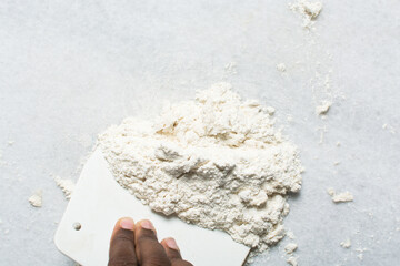 Overhead view of steamed bun dough being mixed on a granite countertop, top view of mantou dough being mixed, process of making steamed milk buns