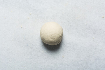Overhead view of steamed bun dough being kneaded, top view of mantou dough being mixed, process of making steamed milk buns