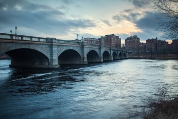 Fototapeta premium This photo shows a river flowing under a bridge with a city in the background Bostons historical cityscape viewed from over the Charles River .