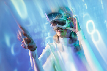 Elderly asian woman exploring virtual reality with headset