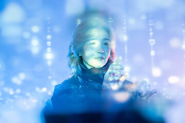 Elderly asian woman interacting in the metaverse