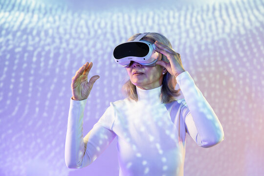 Elderly asian woman experiencing virtual reality immersion