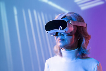 Elderly asian woman exploring virtual reality technology