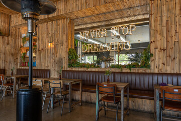 Cozy Rustic Cafe Interior with Neon Sign Never Stop Dreaming