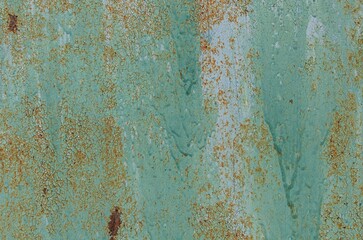 Rusty blue metallic surface with intricate peeling paint patterns revealed over time