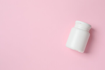 White bottle on color background, top view