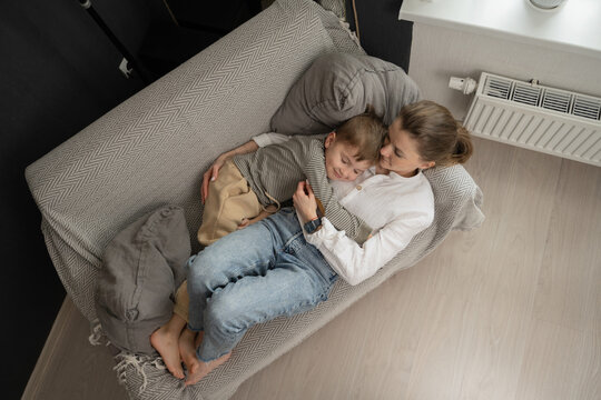Mother and Child Relaxing Together on a Cozy Couch at Home