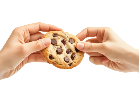 In a warm and welcoming setting, two hands delicately pull apart a freshly baked chocolate chip cookie, releasing its delightful aroma