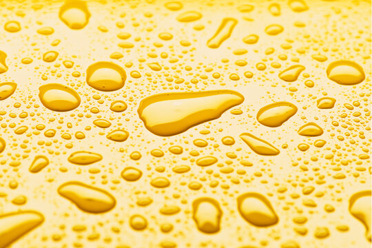 Yellow surface with glossy liquid droplets for texture use