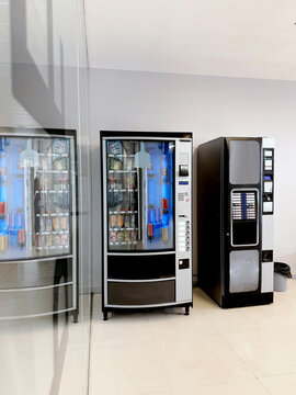 Modern vending machines with snack and drink options in a bright space