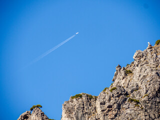Aerial view of a rocky peak with an isolated hiker
