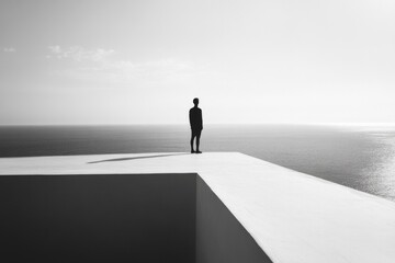 A solitary figure stands on the edge of a white structure, gazing over an expansive ocean horizon, symbolizing the balance between risk, infinity, and future possibilities.