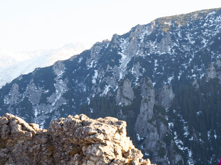 Snow-Capped Mountain Ridge with Rocky Outcrops Viewed from Summit Vantage Point