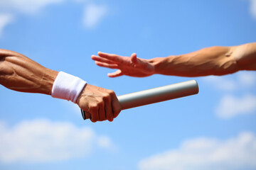 Athletic baton handover during relay race against clear sky