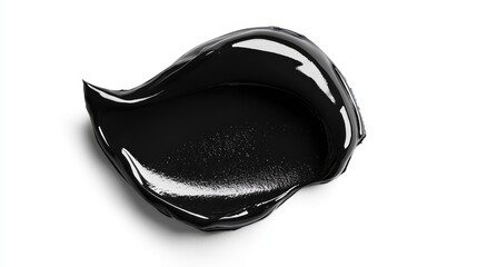 Shiny black paint smear with glossy texture on white background surface.