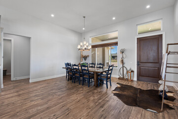Inside a house, there is a cozy dining room featuring a table and chairs