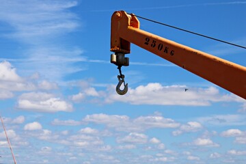 Crane hook and cable on blue sky background