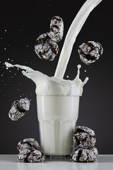 Milk pouring into glass and flying brownies