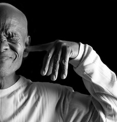 deaf man suffering from deafness and hearing loss on black gray background with people stock photo...