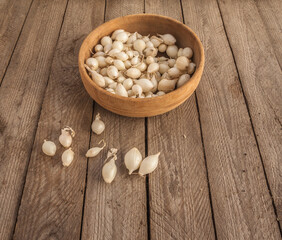 White Onion Sets for Spring Planting on Rustic Wooden Table