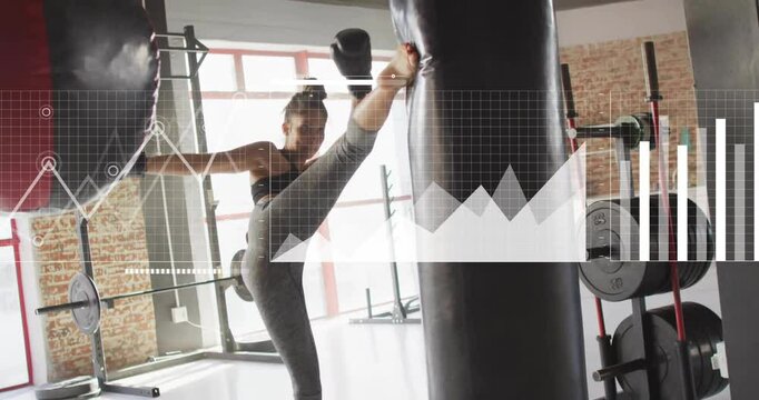 Practicing high kick on punching bag, woman with animation data overlay
