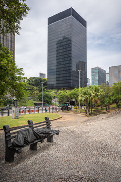 Rio de Janeiro, Brazil - 3 January 2024: Headquarters Building of the Brazilian Development Bank (BNDES), Sculpture "Homeless Jesus" in Foreground; Copy Space