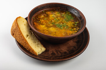 Traditional Ukrainian borscht in a rustic clay bowl, served with sour cream and fresh dill, accompanied by a slice of homemade bread. Classic Slavic cuisine and comfort food