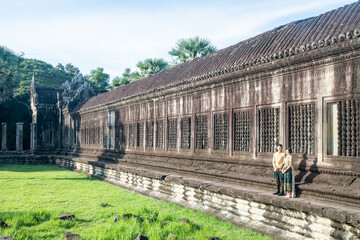 Angkor Wat, A remarkably tall building set against a clear blue sky backdrop