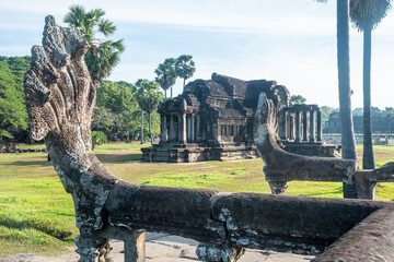 Angkor Wat, A remarkably tall building set against a clear blue sky backdrop