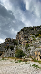 Fototapeta premium Ancient Lycian Rock Tombs In Myra, Turkey, Under Cloudy Winter Sky, Concept Of Archeology, Heritage Preservation, Tourism, Cultural History, And Sustainable Travel