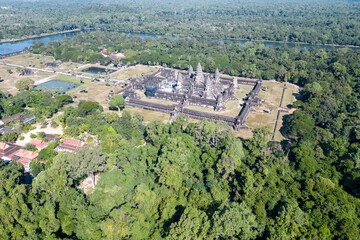 Angkor Wat, A remarkably tall building set against a clear blue sky backdrop