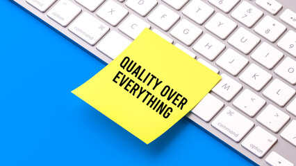 Quality over everything text message, sticky note on computer keyborad