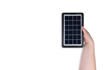 Portable solar panel in hand on transparent background (close-up). Concept of renewable green alternative energy development