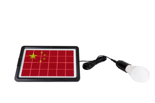 Portable solar panel in the shape of China flag connected to a light bulb on a transparent background (close-up). Concept of developing renewable green alternative energy in China