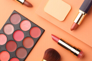 Minimal modern cosmetic scene with make up brushes, eye shadows palette, lipstick, powder and shadow overlay, color of the year 2025 mocha mousse