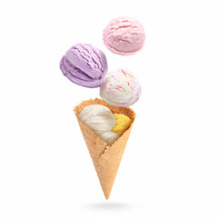 Ice cream scoops and waffle cone in air on white background