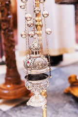 Close-up of an Ornate Incense Burner in an Orthodox Church, With Intricate Designs and Smoke Rising From It