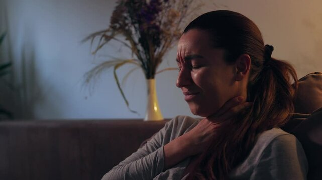 girl clutching her throat, cold, flu, sore throat, girl in bed clutching her throat and writhing in pain