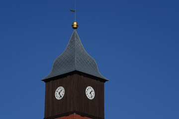 Old clock tower made of dark brown old wood
